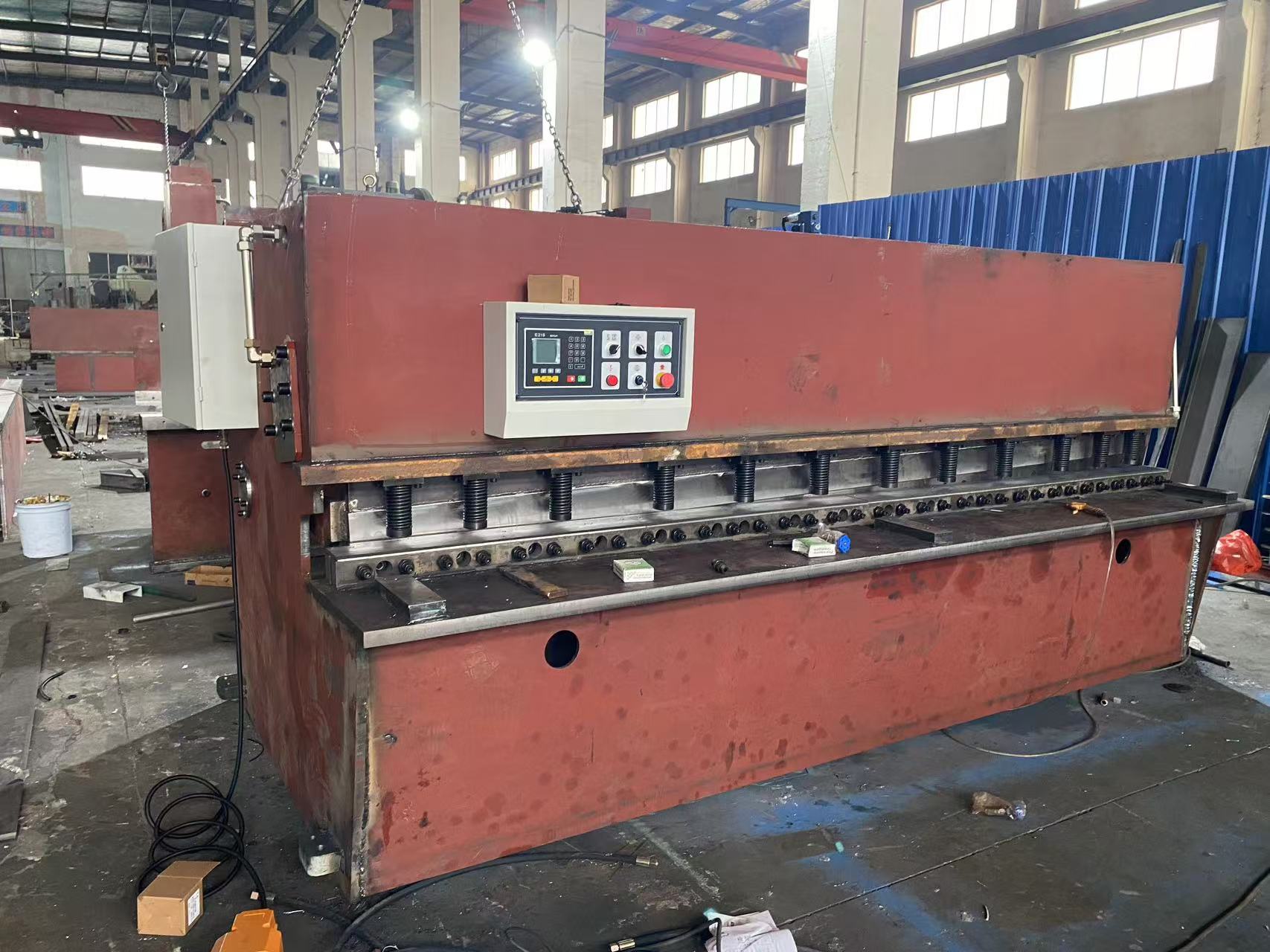 Hydraulic press brake and shearing machine assembly line in manufacturing workshop Hydraulic press brake and shearing machine assembly line in manufacturing workshop