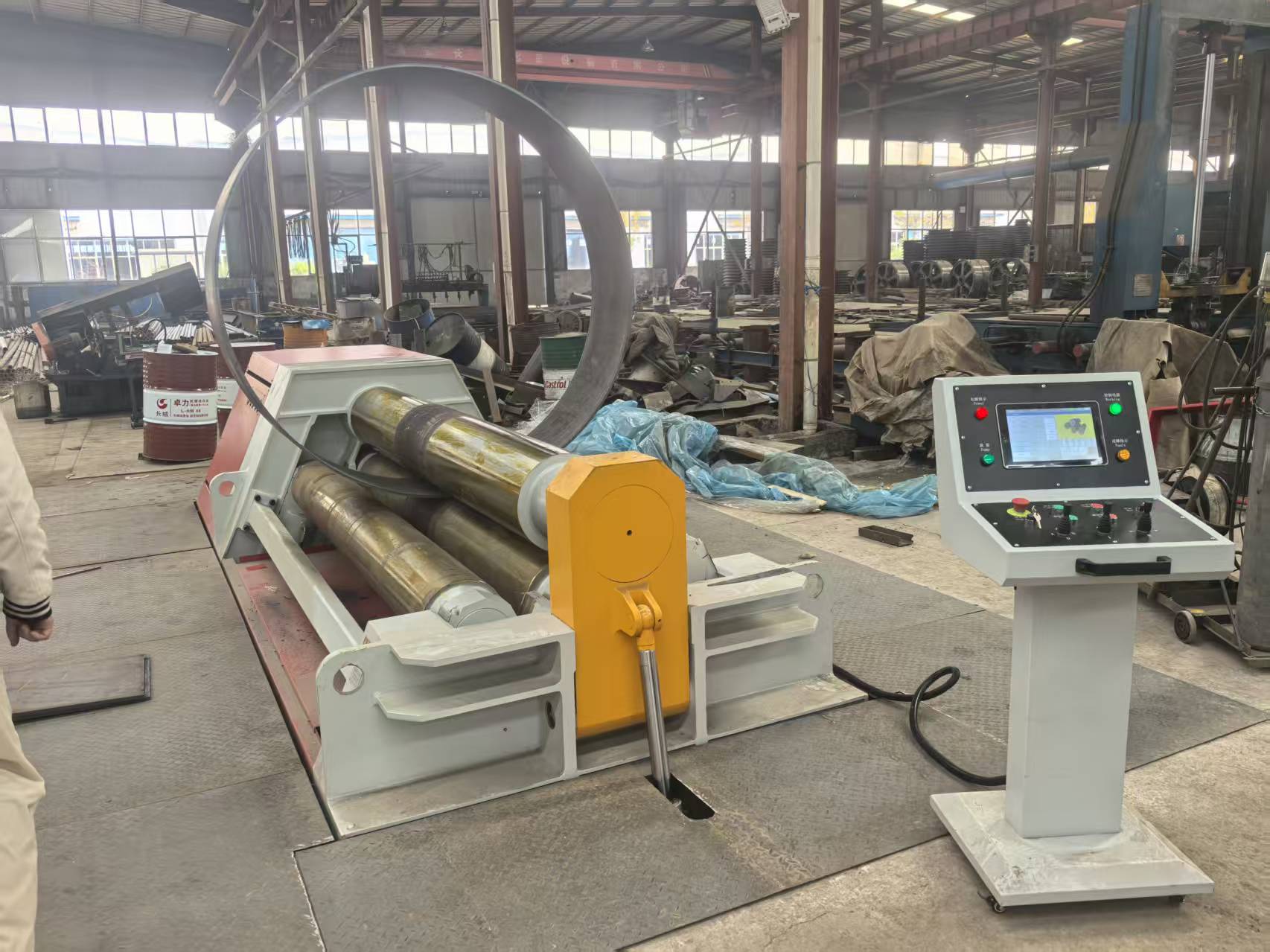 Heavy steel components being lifted by overhead crane for machinery assembly Heavy steel components being lifted by overhead crane for machinery assembly